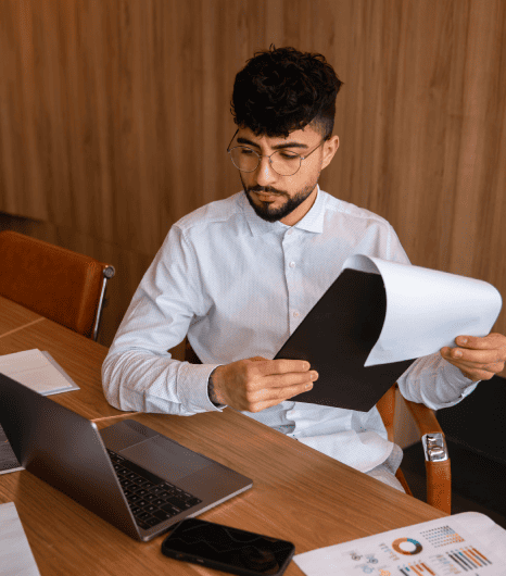 Legal professional reviewing detailed and certified court transcriptions for multiple types of case files. Legal professional reviewing detailed and certified court transcriptions for multiple types of case files.
