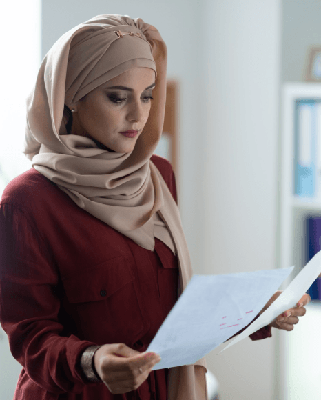 A project manager reviews a Farsi brief and English draft as Farsi Translation Services ensure clear cross-language.