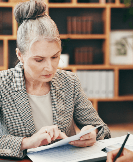A translator edits a crypto whitepaper section on AML controls while fintech translation services ready investor filings.