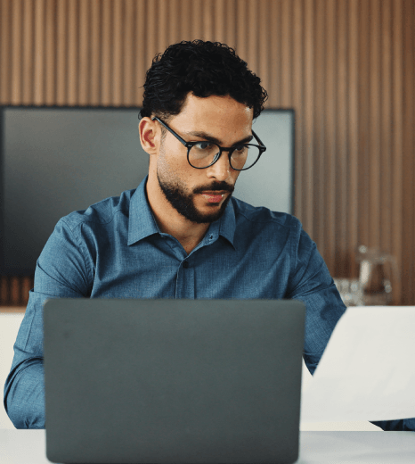 A designer checks translated dashboard copy for a portfolio app as fintech translation services improve UX clarity.