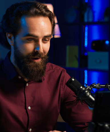 A deep voice actor records in a studio booth while monitoring levels, delivering Voice-Over Services for a video project.