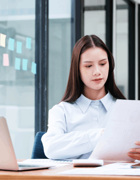 A biotech specialist reviews terminology in a course guide translation while comparing a lab manual and glossary.