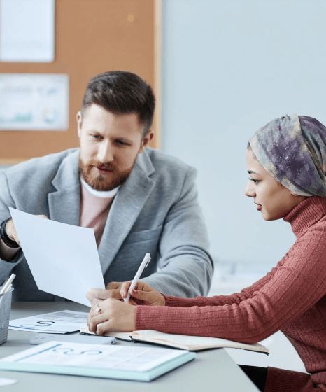 Two reviewers compare bilingual pages as Farsi Translation Services ensure diverse industry documents keep legal intent.