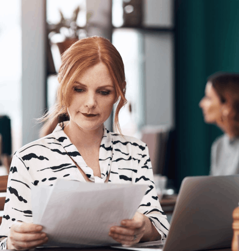 A client reviews a contract, report, and certificate on a desk, using Norwegian translation services for diverse content.