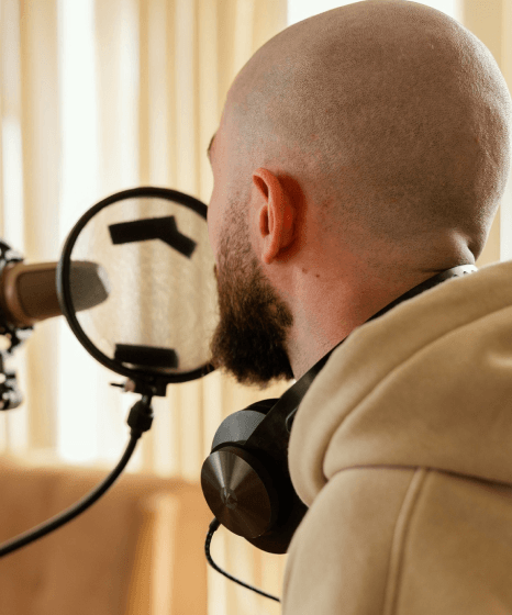 A visitor tests documentary style exhibit audio for a voice over service for museum tour using a handheld museum guide.