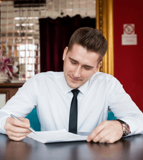A linguist edits a contract and website copy side by side, delivering Croatian translation services for document content.