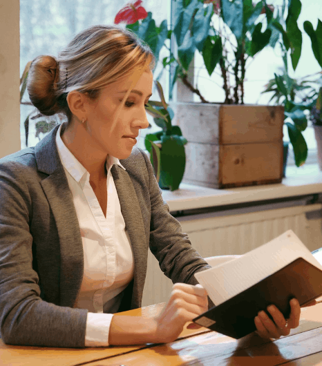 A translator compares Czech and English pages to deliver Czech translation services for document accuracy and clarity.