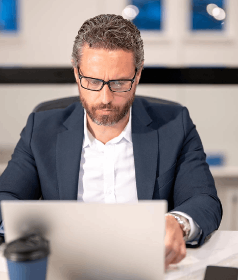 A communications manager checks a formatted quarterly report while Serbian translation services preserve charts and branding.