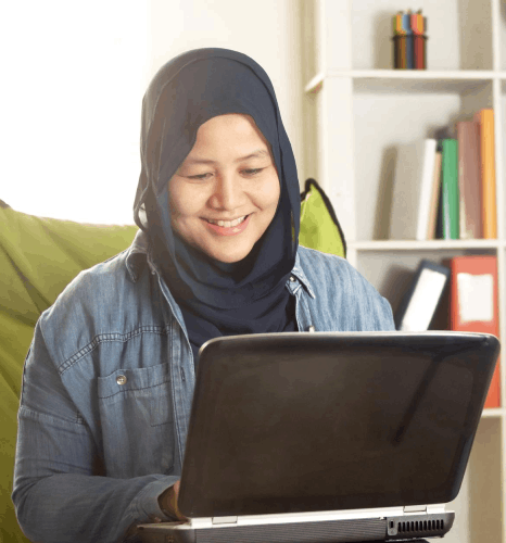 A designer adjusts a brochure layout in InDesign, using Malay translation services for multiformat DTP files.