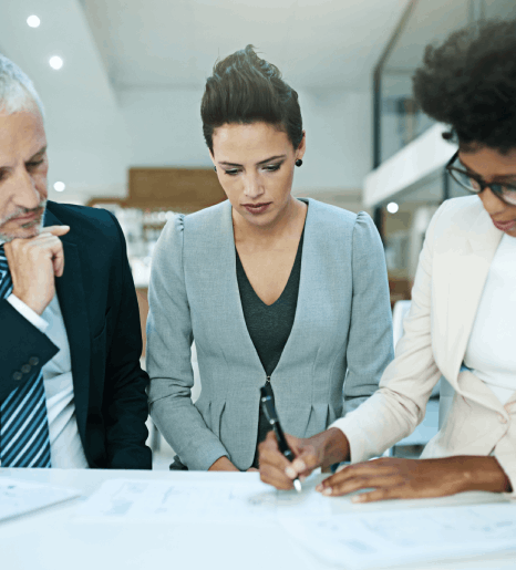 A deal team checks audited pages during due diligence, relying on financial statement translation to verify key figures.