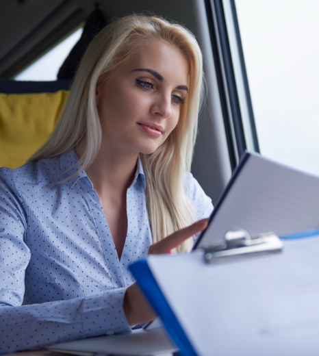 A staffing coordinator reviews an employment eligibility folder that includes a certified license translation from Drivers.