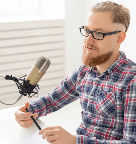 A native Polish voice talent records in a studio booth, providing Polish Voice Over Services for clear.