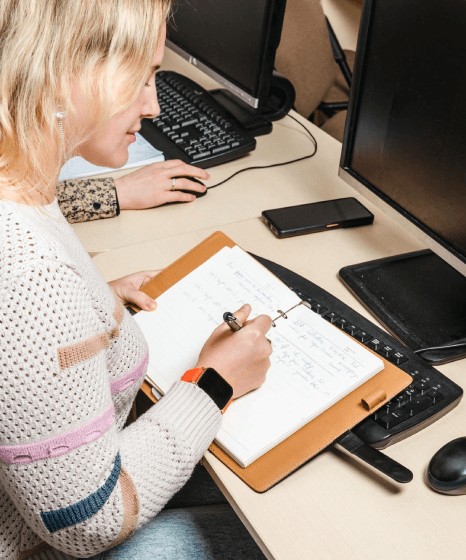 A student drags course notes into a laptop browser while Polish Translation Services handle online class materials.