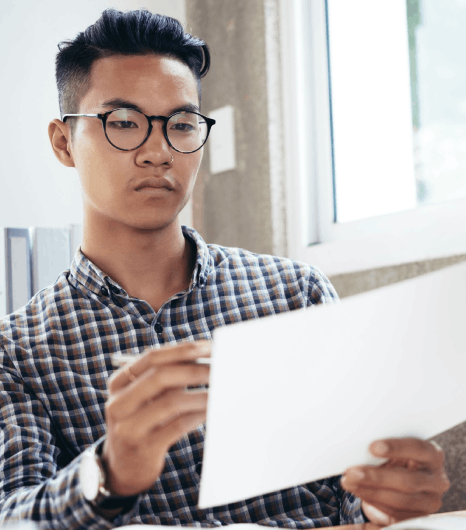 A reviewer compares Thai financial report tables and notes, relying on Thai translation services for finance terms.