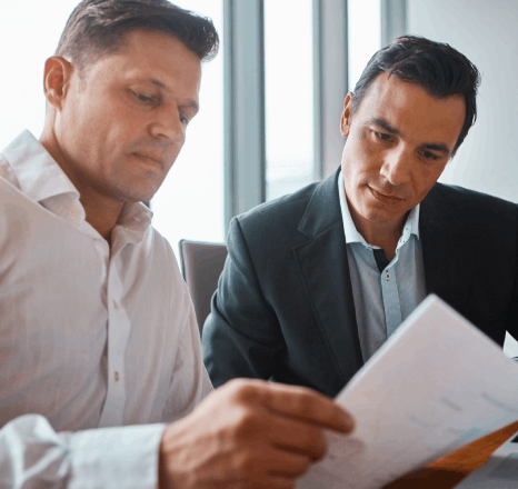 A compliance officer reviews legal policy forms while insurance translation services align wording with new regulations.