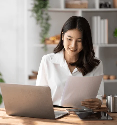 A reviewer highlights names and dates on a translated marriage certificate as urgent translation services prevent USCIS.