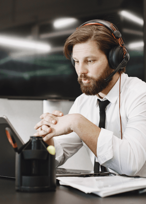 A producer reviews a French Voiceover Services ad spot with a client, timing the narration to match product visuals