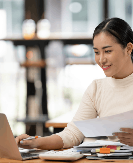 A reviewer verifies tables and decimals in a GAAP report, using corporate document translation services for audits.