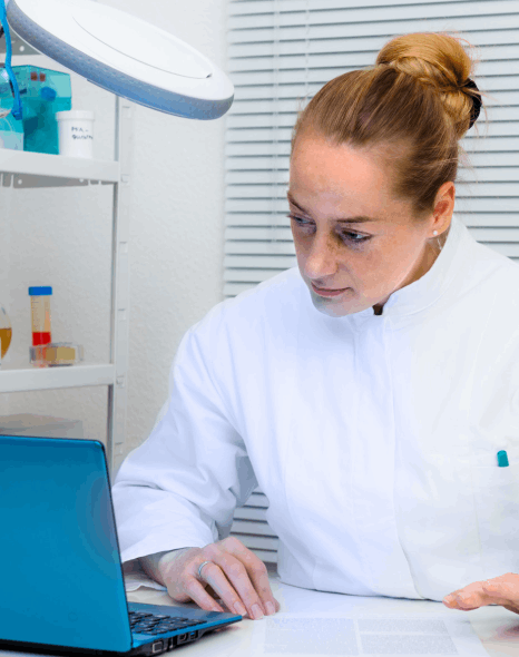 A QA specialist updates a controlled glossary for study records, using life sciences translation services for consistency.