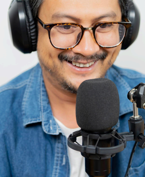 A producer reviews a budget sheet and schedule, choosing language voice over services with clear planning support.