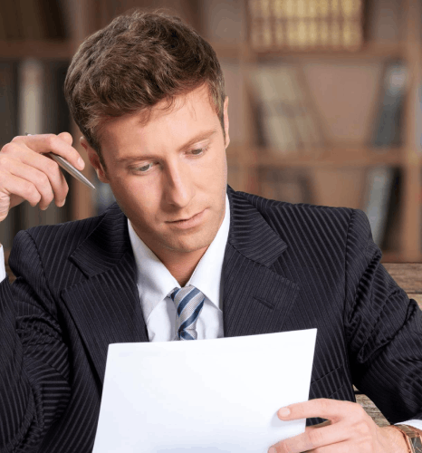 A paralegal reviews a marked-up contract as Hungarian translation services ensure precise legal clauses and defined terms.