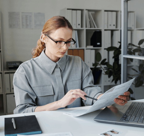 A business analyst highlights industry-specific contract clauses while immediate translation services deliver a clean copy.