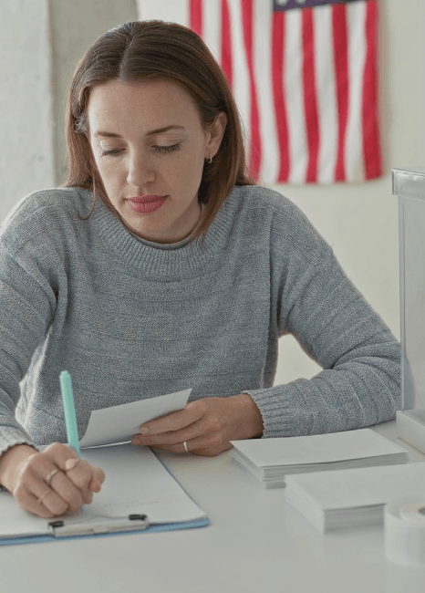 An immigration attorney organizes an evidence binder, using Lithuanian translation services to support a client application.