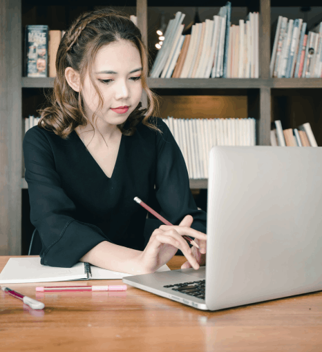 A reviewer verifies names and dates on a certified Vietnamese immigration translation, using Vietnamese Translation Services.
