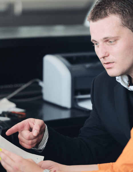 Two reviewers run a terminology checklist as automotive translation services finish an industry technical document set.