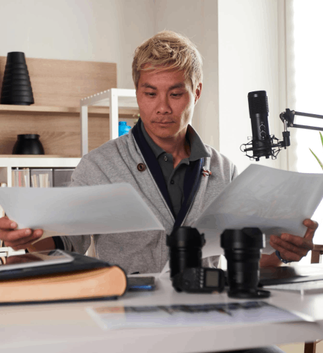 An engineer reviews a Vietnamese user manual draft using Vietnamese Translation Services for precise technical terms.