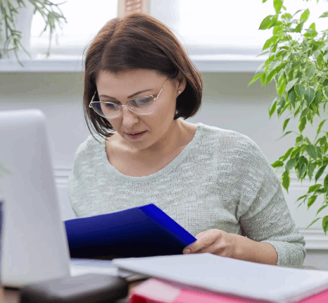 A researcher edits a bilingual journal draft with citations as Serbian translation services keep academic terms consistent.