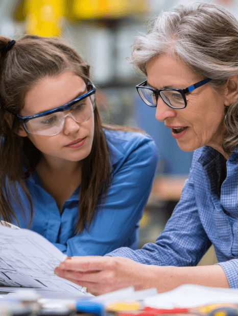 An engineer compares a translated manual, SOP, and shift report, using manufacturing translation services for accuracy.