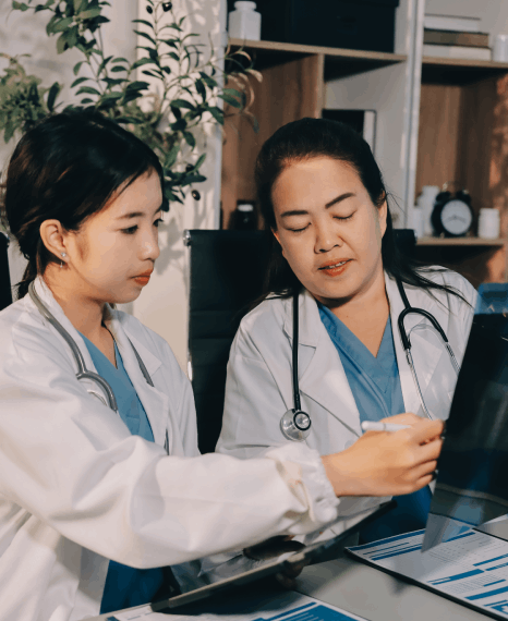 Two nurse review discharge instructions for korean translation services new york so Korean patients understand care steps.