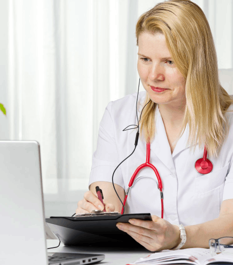 A hospital coordinator prepares discharge forms for Slovenian translation services to share clear medical records abroad.