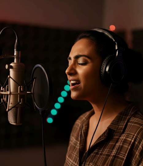 A voice actor speaks into a condenser mic as Spanish Voice Over Services deliver clear studio audio with low noise.
