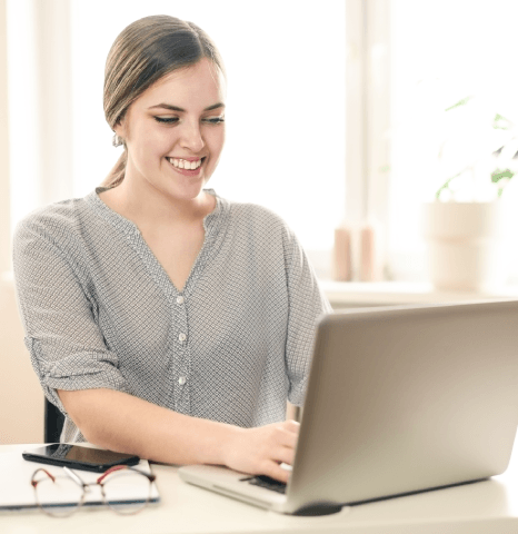 A designer checks print pages and a tablet preview as Magazine Translation Services keep multiformat layouts consistent.