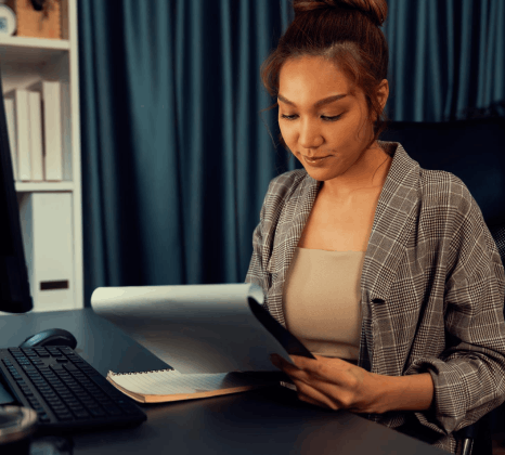 An editor checks Swahili subtitles on a training video while Swahili translation services align multi-format terminology.