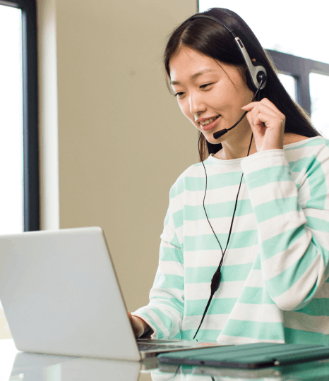 A native speaker records multilingual prompts in a studio as Telephone Voiceover Services support global customer service.