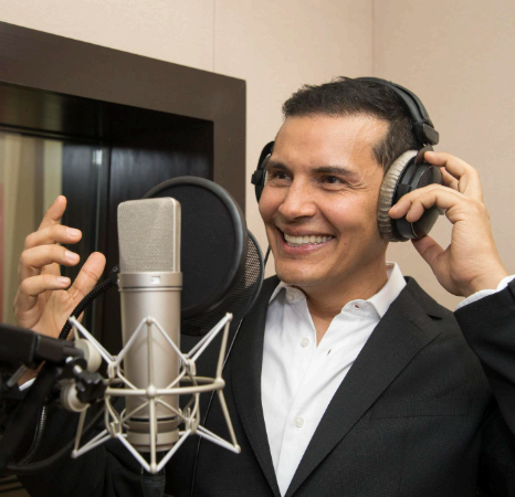 A native-speaking artist marks stress and pronunciation on a script as Portuguese Voice Over Services refine local phrasing.