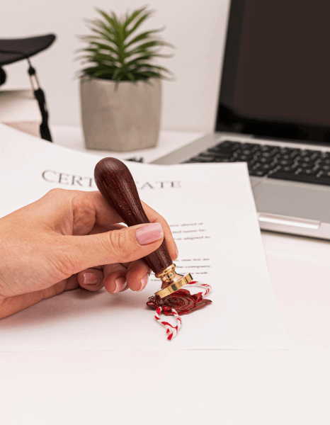 A notary stamps a signed affidavit beside translated pages as same day translation services prepare notarized submissions.
