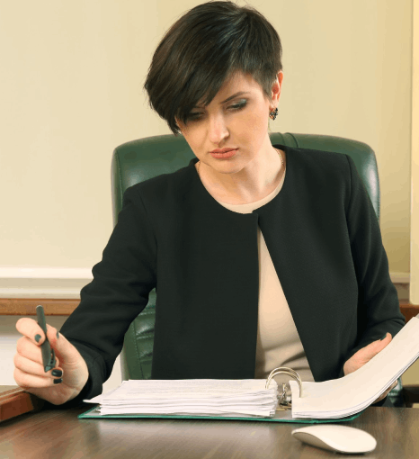 A translator checks seals and names for certified vital document translation for official legal filing packets.