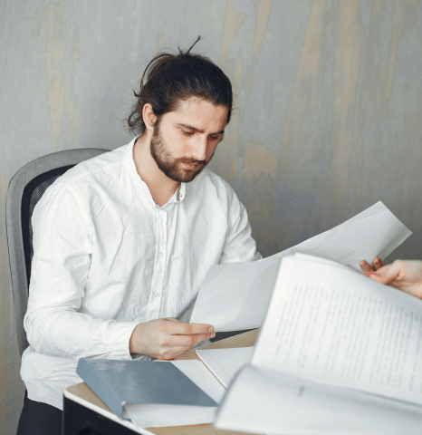 A notary signs a records packet while Swedish translation services align dates, names, and numbered sections exactly.