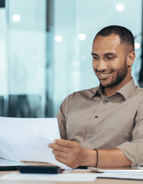 A manager checks a translated work instruction, using corporate document translation services for operational rollout.