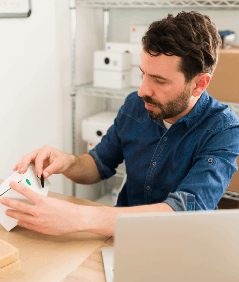 A packaging designer checks a translated carton dieline, confirming pharmaceutical translation services preserve accurate.