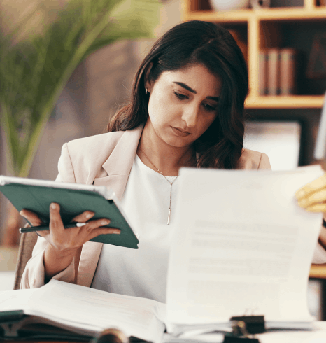 A project manager calculates per-word pricing as Human Resources Translation Services prepare multilingual HR packets.
