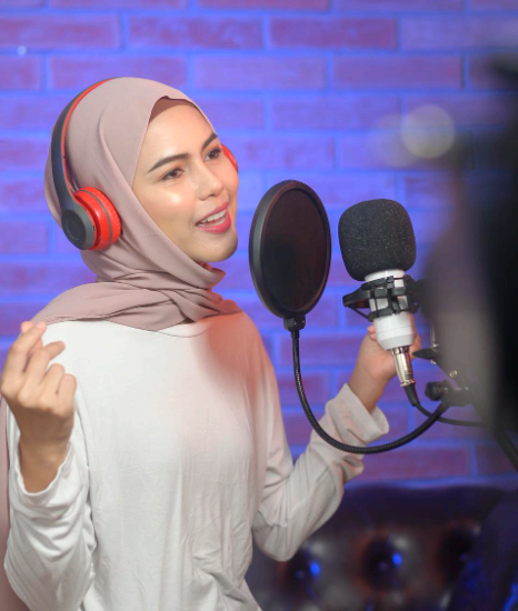 A producer tests Urdu Voice Over Services on phone, laptop, and smart TV to confirm platform-ready playback quality.