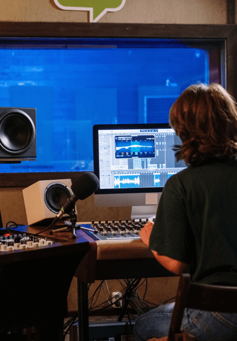 An editor following the process of voiceover services by editing the audio after recording