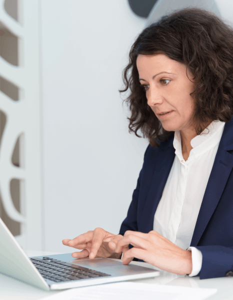 Translator compares source and target survey items on a laptop, using Survey Translation Services to protect reliable data.