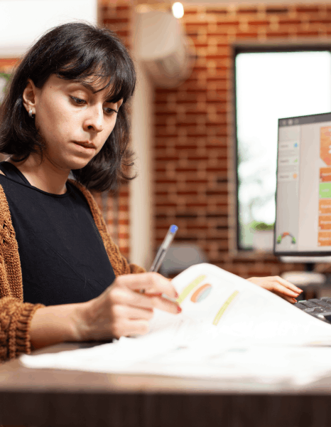 A proofreader compares two report versions to catch financial statement translation errors during a QA workflow.