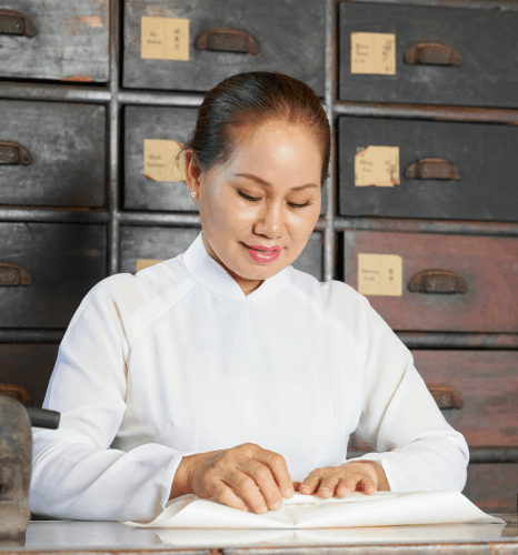A linguist performs thorough quality checks while proofreading a Tibetan report, relying on Tibetan translation services.